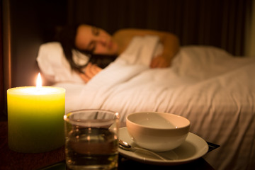 Woman relaxing in bed (dish focus)