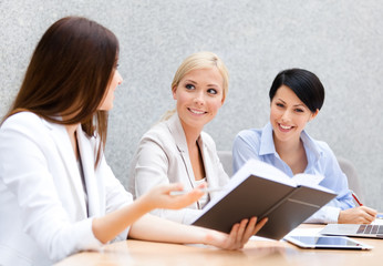 Female colleagues discuss business strategy