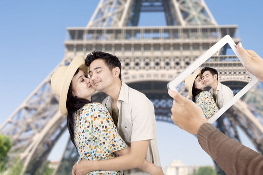 Asian couple took picture at eiffel tower Paris