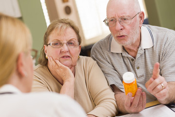 Doctor or Nurse Explaining Prescription Medicine to Senior Coupl