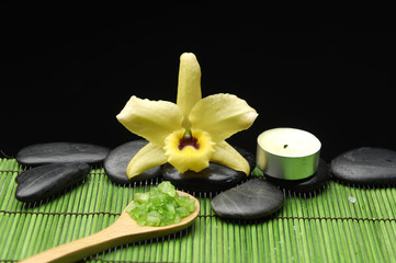 orchid flower, with zen stone and candle on green mat