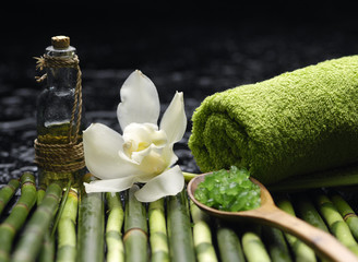 salt in spoon with massage oil with towel grove on mat