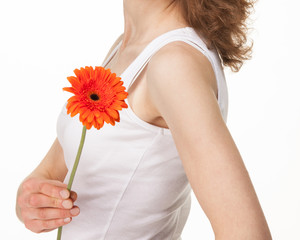 Young woman with a red gerber flower