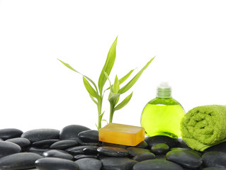 Bamboo leaf and basalt stones with green towel with soap