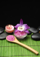 Spa setting with Pink orchid, candle with zen stone