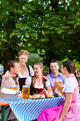 In Beer garden - friends on a table with beer