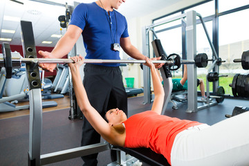 Fototapeta na wymiar woman and Personal Trainer in gym