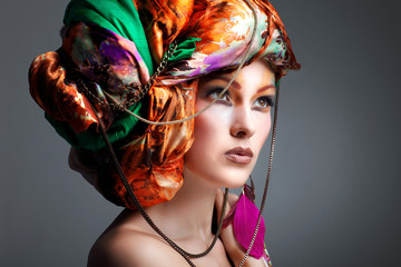 beautiful girl in a head-dress from the coloured fabric