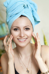 Beautiful woman applying moisturizer cream. girl face