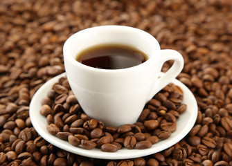 Cup of coffee on coffee beans background