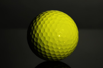 Golf ball on grey background