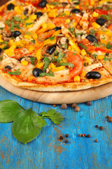 Tasty pizza on blue wooden table close-up