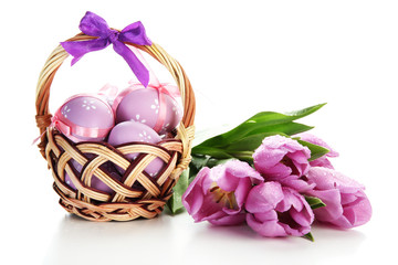 Fototapeta na wymiar Bright easter eggs in basket and tulips, isolated on white