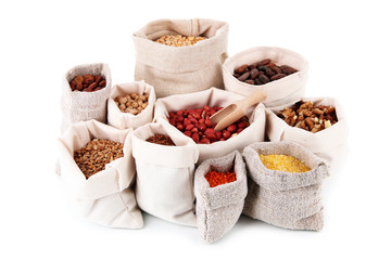 Different kinds of beans in sacks isolated on white