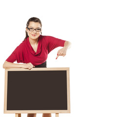 girl with glasses, standing behind an empty table to show someth