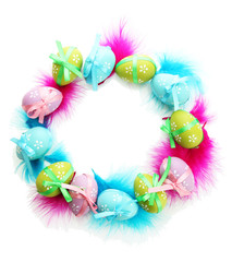 Wreath of bright easter eggs and decorative feathers, isolated