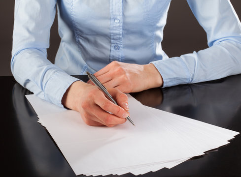 Businesswoman writing down notes