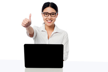 Businesswoman showing thumbs up gesture