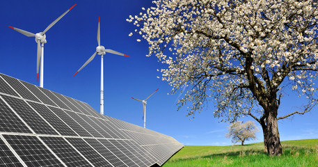 Spring landscape with solar panels and wind turbines