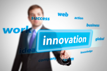 businessman hand pushing innovation button