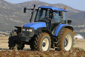 tractor plowing the field on mountains