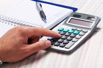 Hand with calculator.