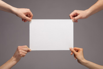 Hands holding paper