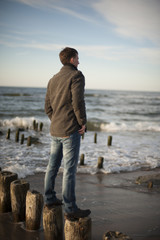 Man standing at breakwaters