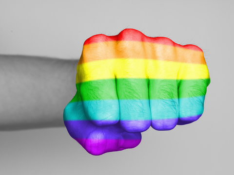 Fist of a man punching, rainbow flag pattern