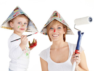 Cute boy and his mother painting together