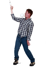 Man with light bulb in the mouth