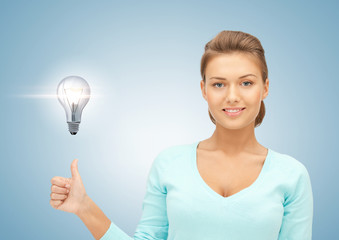 woman with light bulb showing thumbs up