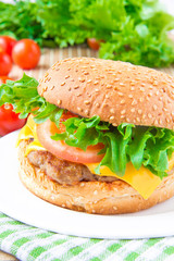 Tasty american lunch - cheeseburger with meat cutlet, cheese and