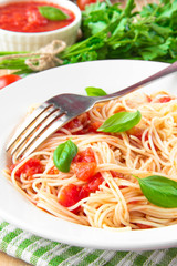 Traditional Italian tasty meal pasta with tomato sauce and basil