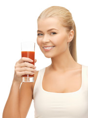 woman holding glass of tomato juice