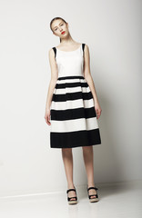 Elegant Woman Fashion Model in Light Striped Cotton Sundress