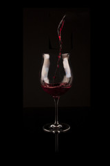 Red wine pouring in glass