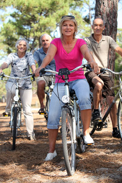 Two middle-aged couples riding bicycles