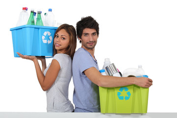 Young couple recycling bottles