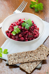 Salad with beetroot, potatoes, pickled cucumber and green peas