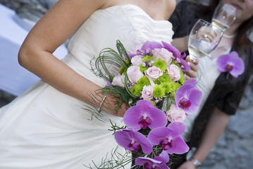 Bride holding whine glass and beautiful bridal bouquet