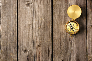 Fototapeta na wymiar Antique compass over wooden background