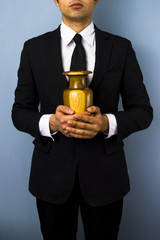 Man with wooden urn