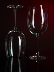Two glasses on dark red background