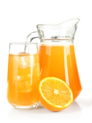 Glass and pitcher of orange juice isolated on white