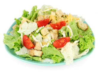 Caesar salad on blue plate, isolated on white