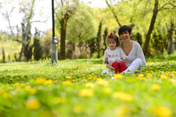 Fototapeta premium Mother and little girl playing in the park