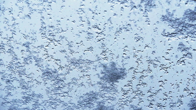 Snow melting on window