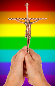 Old woman with catholic crucifix, isolated, rainbow flag pattern