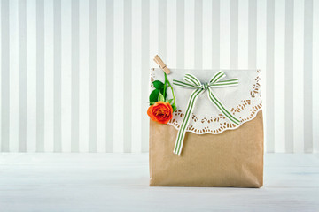 Brown paper gift bag decorated with doily
